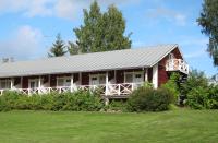 a red house with a gray roof and a yard at Tertin Kartano in Mikkeli