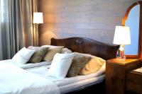 a bedroom with a bed with white sheets and pillows at Tertin Kartano in Mikkeli