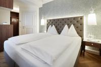 A bed or beds in a room at Gasthof Hotel Zweimüller