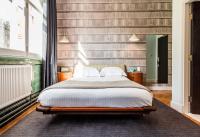 a bedroom with a large bed and a large window at ABode Manchester in Manchester