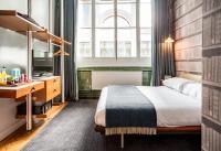 a hotel room with a bed and a desk at ABode Manchester in Manchester