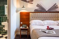 a hotel room with a bed and a book on a table at ABode Manchester in Manchester