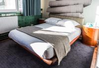 a bedroom with a bed with a pile of blankets at ABode Manchester in Manchester