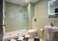 a bathroom with a toilet and a sink and a shower at ABode Manchester in Manchester