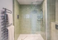 a bathroom with a glass shower with a toilet at ABode Manchester in Manchester