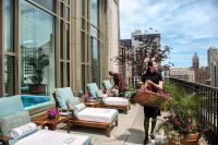 a woman walking on the balcony of a building at The Peninsula Chicago in Chicago