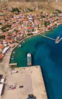 an aerial view of a harbor with a boat in the water at Amazing House in Halki in Halki