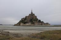 an island in the ocean with a castle on it at Le Mouton Blanc in Le Mont Saint Michel