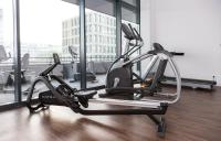 a gym with a treadmill in front of a window at Résidence Odalys Nantes Cité des Congrès in Nantes