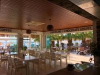 オータキャンツにあるZest Exclusive Hotel & Spaのテーブルと椅子、パティオ付きのレストラン