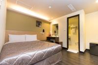 a hotel room with a bed and a bathroom at Chance Hotel in Taichung