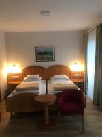 A bed or beds in a room at Aurora Panzió