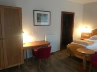 A bed or beds in a room at Aurora Panzió