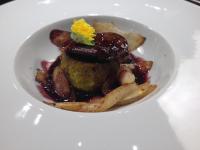 Un tazón de comida con patatas y una flor encima. en Apartment Hotel Marchesini, en Rávena