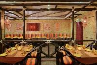 a restaurant with tables and chairs in a room at Fortune Resort Heevan, Srinagar - Member ITC Hotels' Group in Srinagar