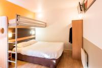 a small room with a bed and a bunk bed at Premiere Classe Annecy Nord - Epagny in Épagny