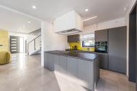 a kitchen with a large island in a room at Contemporary Villa Nada with Pool and Sauna in Tinjan