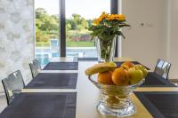 a vase filled with oranges and bananas on a table at Contemporary Villa Nada with Pool and Sauna in Tinjan