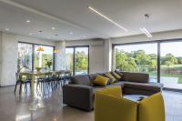 a living room with a couch and a table at Contemporary Villa Nada with Pool and Sauna in Tinjan