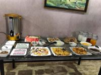 ein Tisch mit vielen verschiedenen Arten von Essen darauf in der Unterkunft TOURIST INN hotel in Taschkent