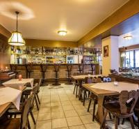 a restaurant with tables and chairs and a bar at Hotel Le Postillon in Esch-sur-Sûre