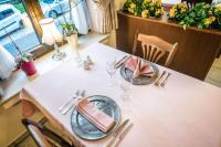 a white table with plates and silverware on it at Hotel Le Postillon in Esch-sur-Sûre