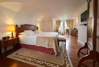 a bedroom with a bed and a living room at PortoBay Serra Golf in Santo António da Serra