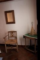 a chair and a table in a room with a mirror at La Carrihuela in Algodonales