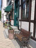 a wooden bench sitting outside of a building at Pension Karina Schwerin in Schwerin