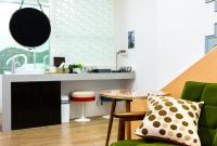 a kitchen with a table and a green chair at 321 Apartment B&amp;B in Hualien City