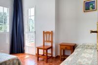 A bed or beds in a room at Duerming San Vicente Hotel