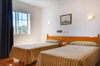 A bed or beds in a room at Duerming San Vicente Hotel
