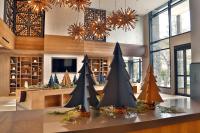 a lobby with a display of christmas trees on a table at Entourage sur-le-Lac in Lac-Beauport