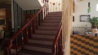 a staircase in a home with wooden railings at See Starsea Guest House in Magong