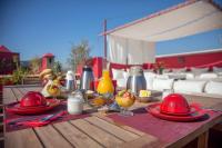 a wooden table with plates of food on a patio at Riad Dar Karma in Marrakech