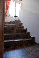 a set of stairs in a building with a window at Almwirt in Bramberg am Wildkogel