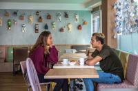 a man and woman sitting at a table in a restaurant at Hotel Espresso in Amsterdam