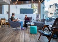 a man and woman sitting in chairs in a room at Hotel Espresso in Amsterdam
