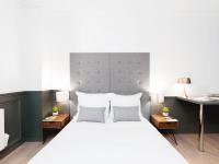 a bedroom with a large white bed and a desk at LivinParis - Luxury 3 Bedrooms République I in Paris