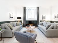 a living room with two couches and a table at LivinParis - Luxury 3 Bedrooms République I in Paris