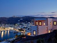 a house with a view of a harbor at night at Patmos Eye Boutique Hotel &amp; Villas in Skala