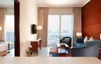a hotel room with a view of a living room at Treppan Hotel & Suites By Fakhruddin in Dubai