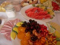 a table topped with plates of fruit and vegetables at Adam & Eva Gasthof Paradies mit Hotel in Vogt