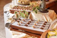 a table with a buffet of appetizers and desserts at Beijing Hotel Minsk in Minsk