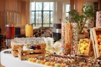 a buffet of food on a table in a room at Beijing Hotel Minsk in Minsk