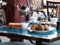 a table with a plate of food and a tea kettle at Jumeirah Mina Al Salam Dubai in Dubai