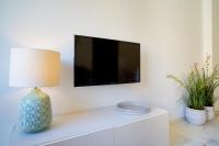 Televízia a/alebo spoločenská miestnosť v ubytovaní iloftmalaga Puerta del Mar