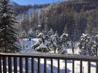 a snow covered tree sitting on top of a balcony at Serre Chevalier -Cosy Apartment &quot;Le Coolidge&quot; for 7 down the slopes with stunning view in Saint-Chaffrey