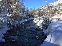a river with snow on the sides of it at Serre Chevalier -Cosy Apartment &quot;Le Coolidge&quot; for 7 down the slopes with stunning view in Saint-Chaffrey