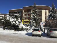 two cars parked in a parking lot in front of a building at Serre Chevalier -Cosy Apartment &quot;Le Coolidge&quot; for 7 down the slopes with stunning view in Saint-Chaffrey